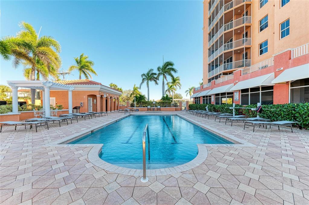 3191 Matecumbe Key Road, Unit 307 Punta Gorda, FL 33955 - Photo 3 of 40 a view of a swimming pool with a lounge chairs