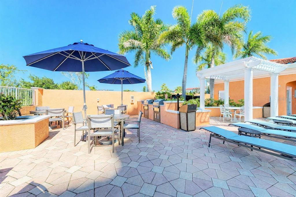 3191 Matecumbe Key Road, Unit 307 Punta Gorda, FL 33955 - Photo 36 of 40 a outdoor space with furniture and umbrella