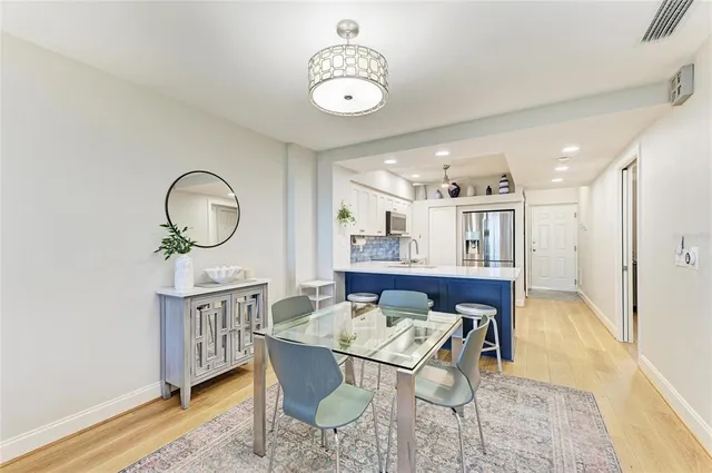 a view of a dining room with furniture and a chandelier