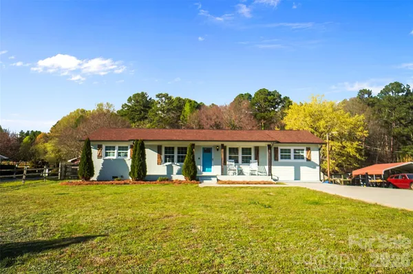 a front view of a house with swimming pool yard and outdoor seating