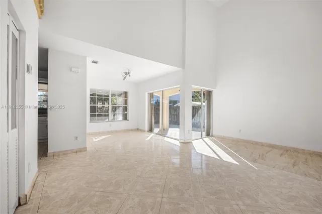 an empty room with windows and pillars in it