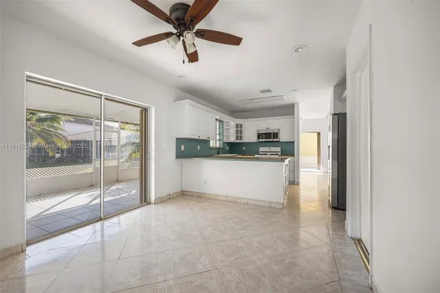 a view of a kitchen with a sink and refrigerator