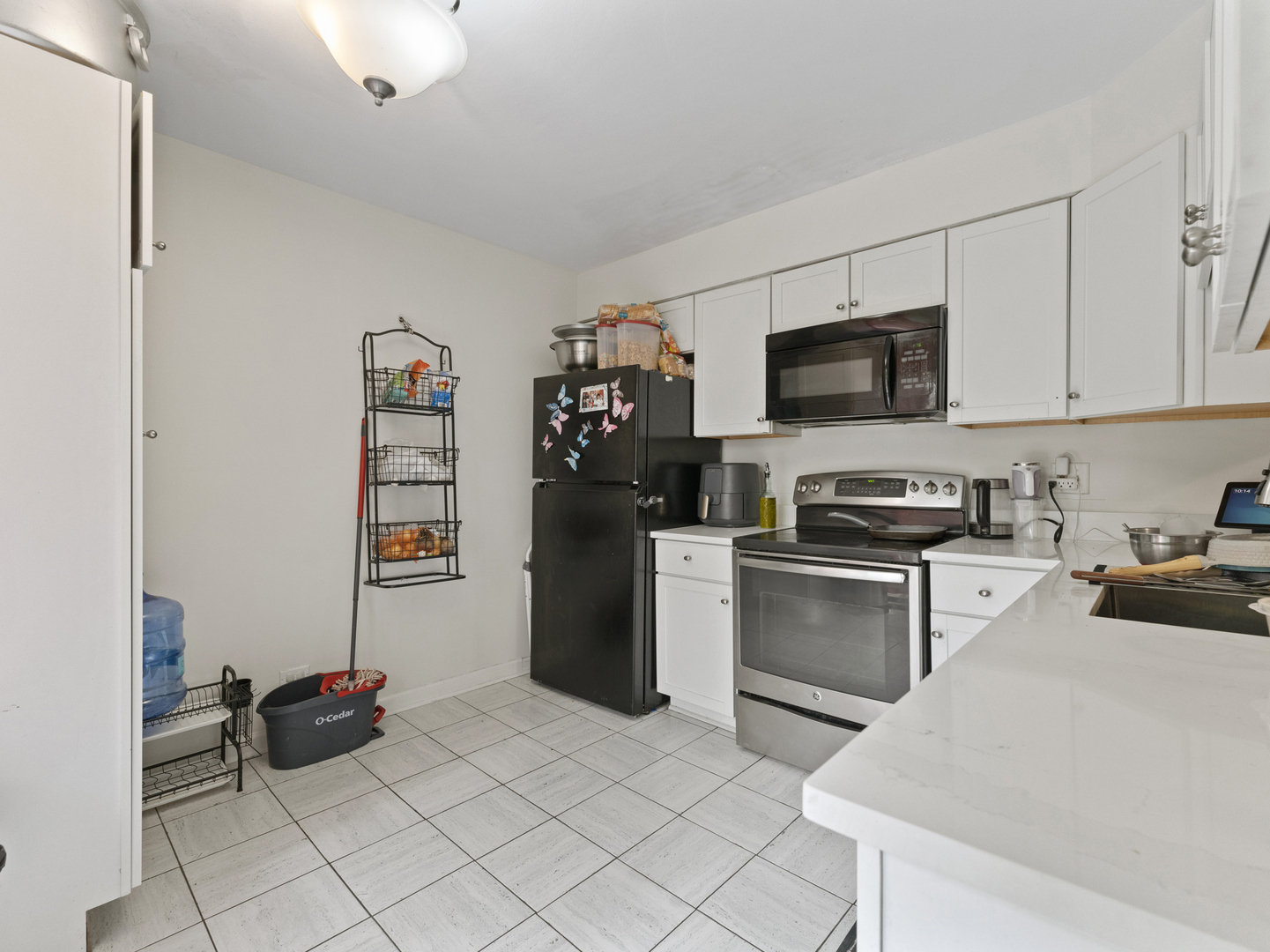 741 Colby Court Gurnee, IL 60031 - Photo 6 of 16 a kitchen with a refrigerator and a stove top oven