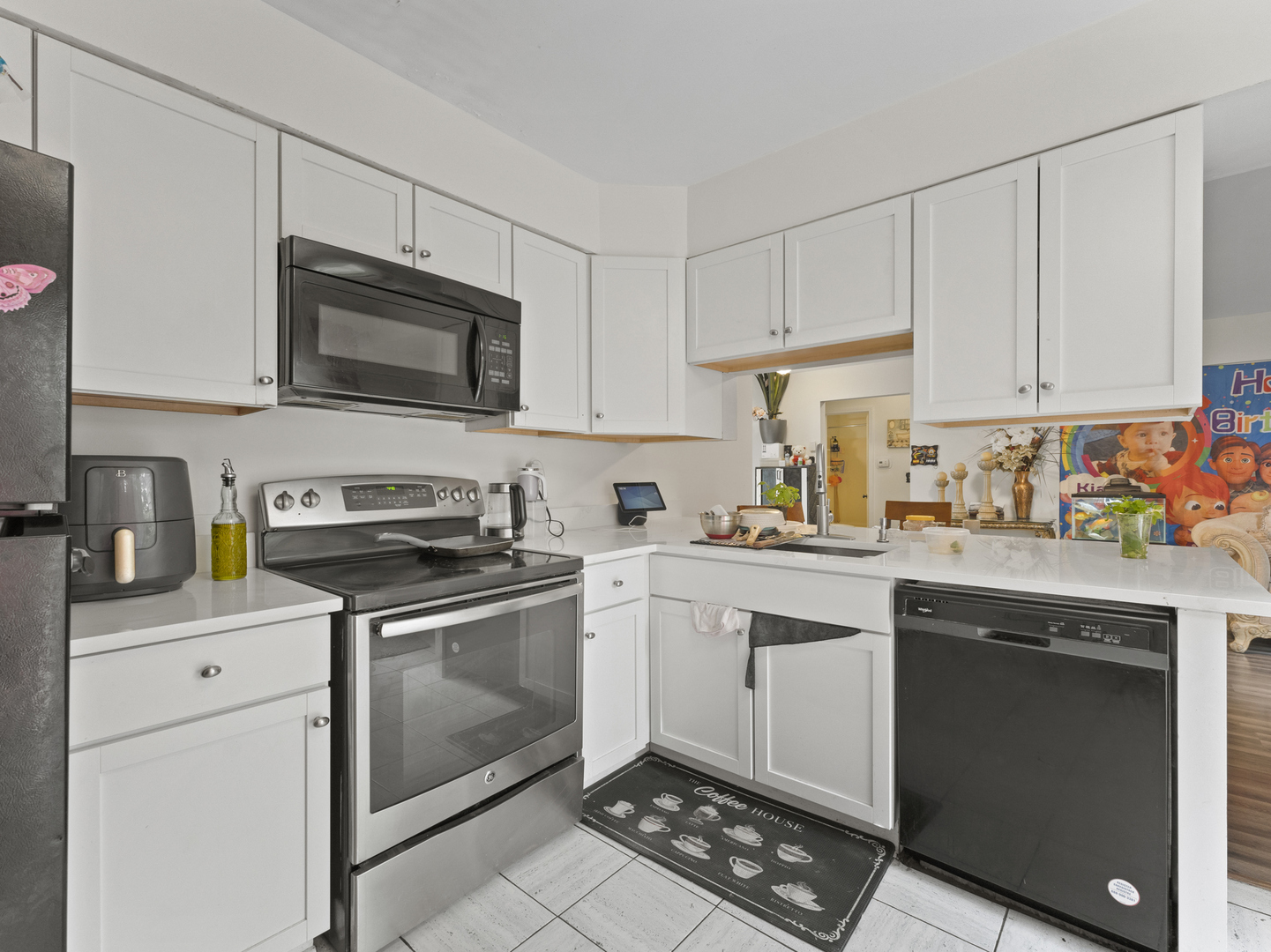 741 Colby Court Gurnee, IL 60031 - Photo 7 of 16 a kitchen with stainless steel appliances granite countertop a stove a sink and a microwave