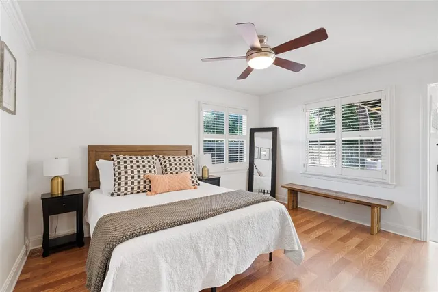 a bedroom with a large bed and a large window