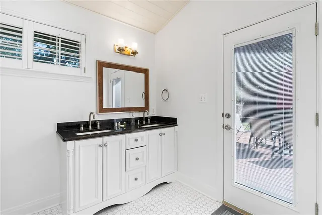 a bathroom with a sink a vanity and a mirror