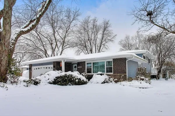 a front view of house with yard and trees around