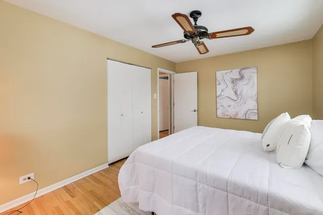 a bedroom with a bed and a painting on the wall