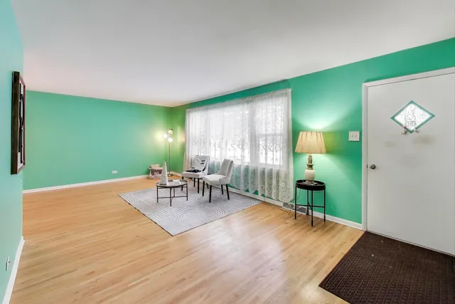 a view of a livingroom with furniture and a window