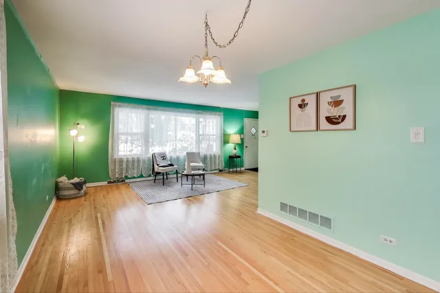 a view of a livingroom with furniture window and wooden floor