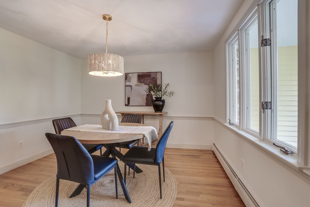 16 Fox Run Road Bedford, MA 01730 - Photo 13 of 37 a view of a dining room with furniture window and wooden floor