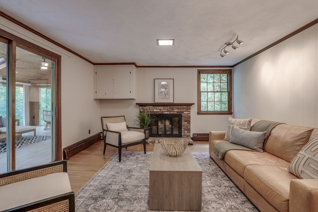 16 Fox Run Road Bedford, MA 01730 - Photo 14 of 37 a living room with furniture a large window and a fireplace