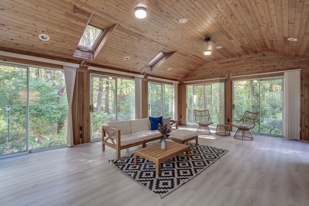 16 Fox Run Road Bedford, MA 01730 - Photo 17 of 37 a living room with furniture floor to ceiling window and wooden floor