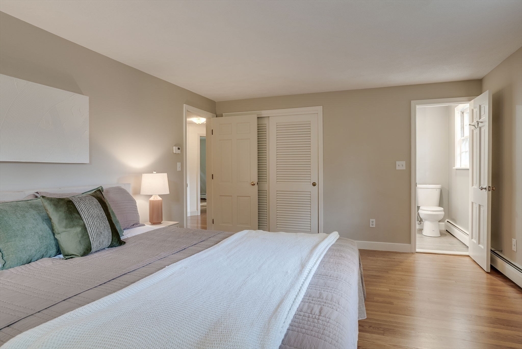 16 Fox Run Road Bedford, MA 01730 - Photo 21 of 37 a spacious bedroom with a bed and a couch