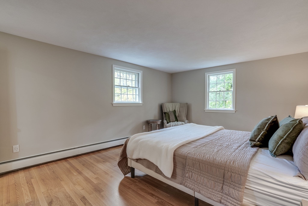 16 Fox Run Road Bedford, MA 01730 - Photo 22 of 37 a bedroom with a bed and wooden floor