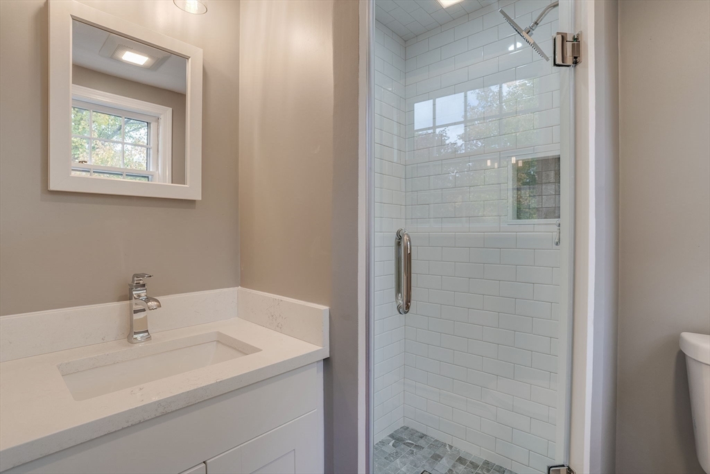 16 Fox Run Road Bedford, MA 01730 - Photo 23 of 37 a bathroom with a sink and mirror
