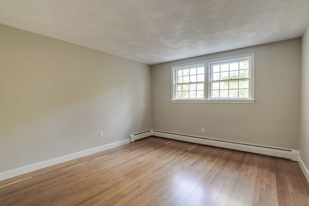16 Fox Run Road Bedford, MA 01730 - Photo 24 of 37 an empty room with wooden floor and windows