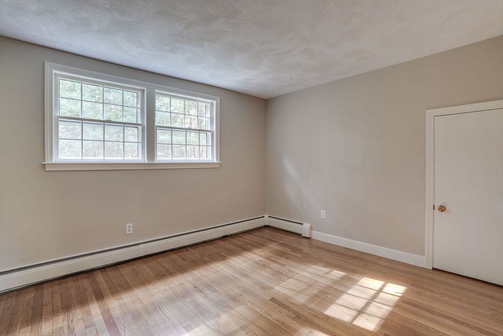 16 Fox Run Road Bedford, MA 01730 - Photo 25 of 37 wooden floor in an empty room with a window