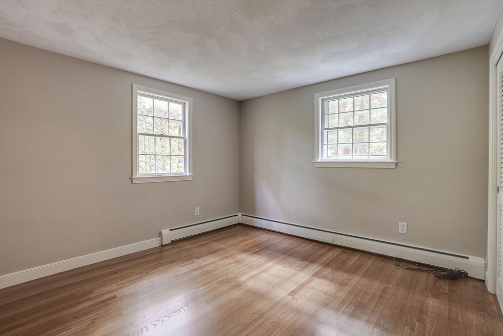 16 Fox Run Road Bedford, MA 01730 - Photo 26 of 37 an empty room with wooden floor and windows