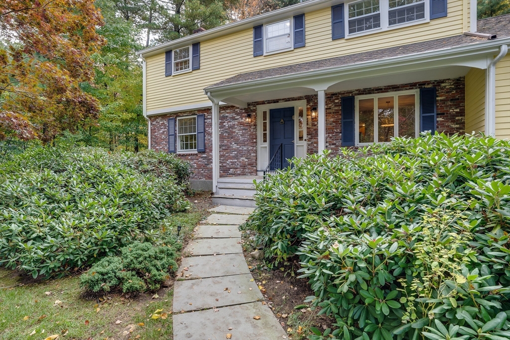 16 Fox Run Road Bedford, MA 01730 - Photo 28 of 37 front view of a house with potted plants