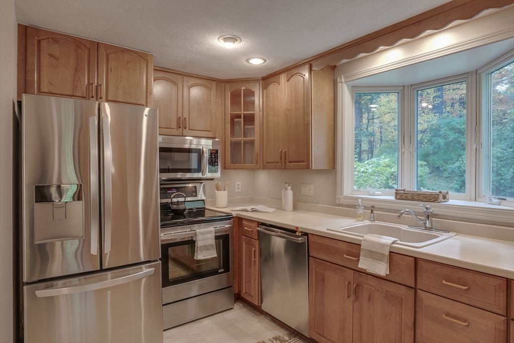 16 Fox Run Road Bedford, MA 01730 - Photo 8 of 37 a kitchen with a refrigerator sink and window