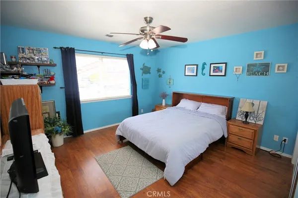 a bedroom with a bed dresser and a window