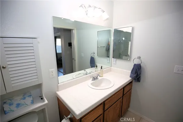 a bathroom with a sink vanity and mirror