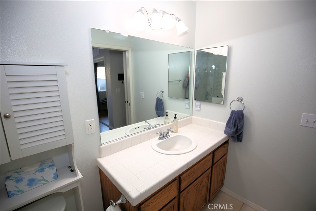 171 Bridgegate Lane Paso Robles, CA 93446 - Photo 19 of 37 a bathroom with a sink vanity and mirror