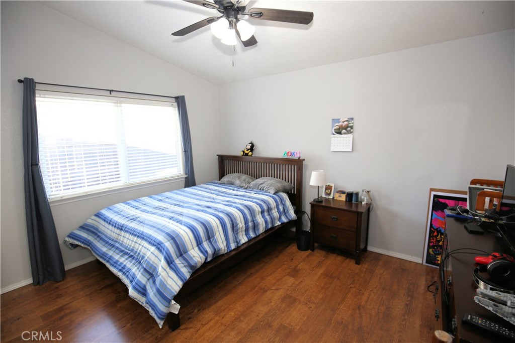 171 Bridgegate Lane Paso Robles, CA 93446 - Photo 21 of 37 a bedroom with a bed and a chandelier