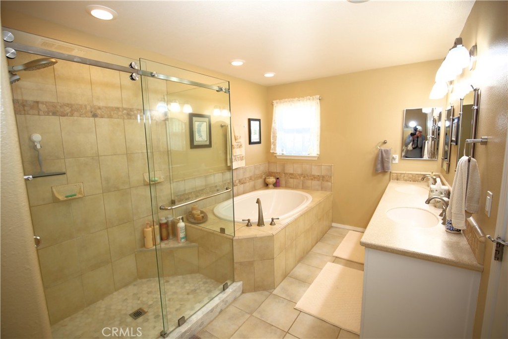 171 Bridgegate Lane Paso Robles, CA 93446 - Photo 24 of 37 a bathroom with a tub a sink a mirror and a shower