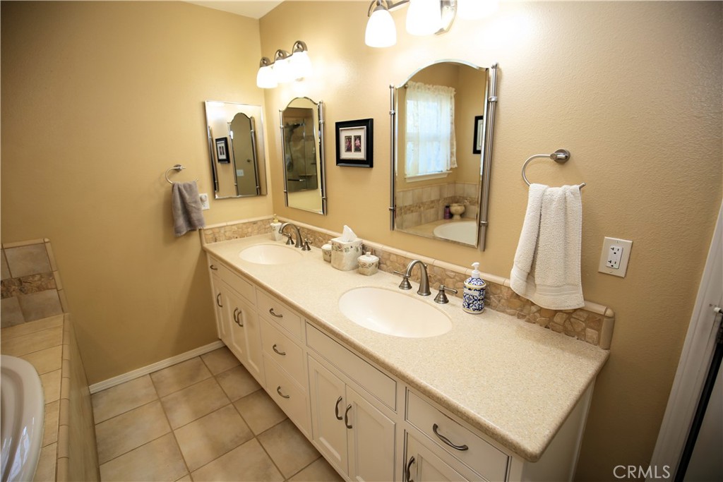 171 Bridgegate Lane Paso Robles, CA 93446 - Photo 26 of 37 a bathroom with a double vanity sink mirror and shower