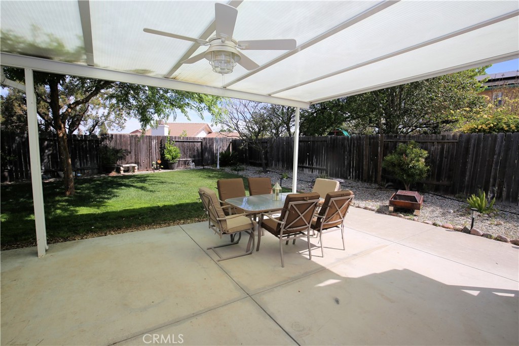 171 Bridgegate Lane Paso Robles, CA 93446 - Photo 28 of 37 a view of a patio with table and chairs under an umbrella with a small yard