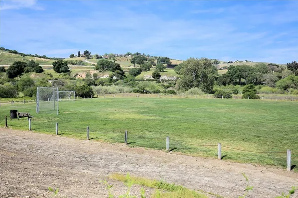 a view of a field with an ocean view