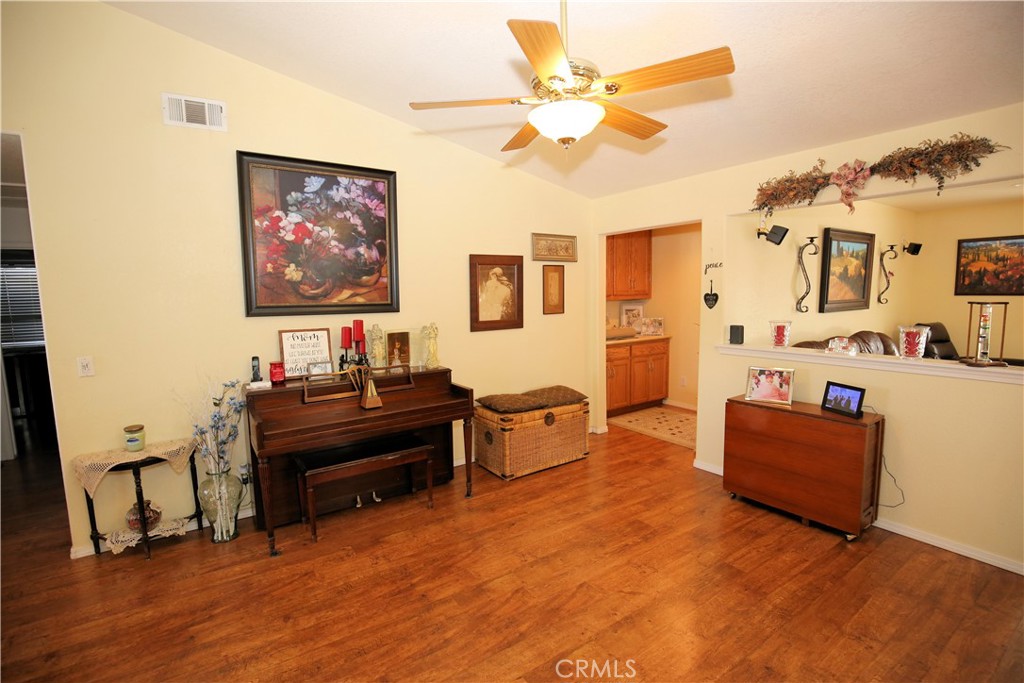 171 Bridgegate Lane Paso Robles, CA 93446 - Photo 4 of 37 a living room with furniture and a flat screen tv with wooden floor