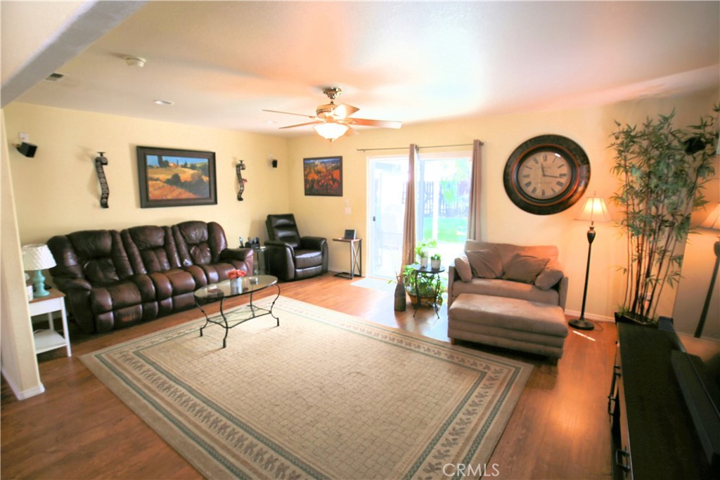 171 Bridgegate Lane Paso Robles, CA 93446 - Photo 6 of 37 a living room with furniture a clock and a rug