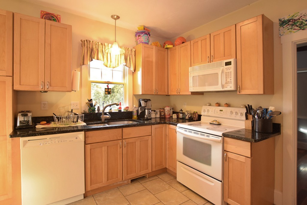 16 Shaw Road Fairhaven, MA 02719 - Photo 3 of 14 a kitchen with a sink stove and cabinets