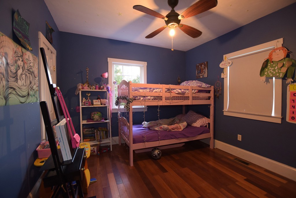 16 Shaw Road Fairhaven, MA 02719 - Photo 6 of 14 a bedroom with a bed and a chandelier