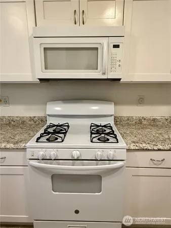 a stove top oven sitting inside of a kitchen