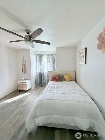 a bedroom with a large bed and a chandelier