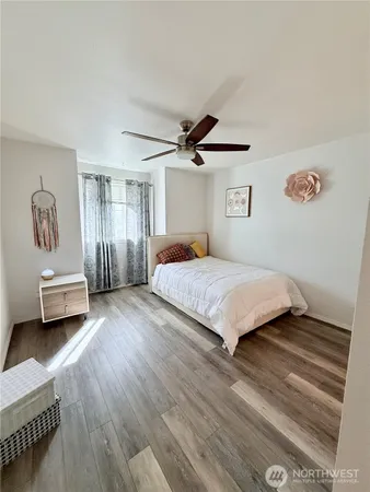 a bedroom with a bed and a ceiling fan