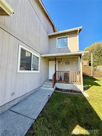 a view of a house with a yard and wooden deck