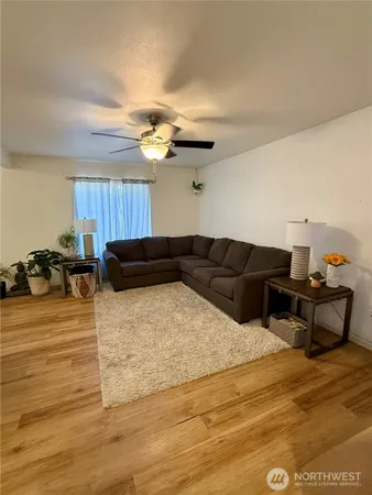 a living room with furniture and a chandelier