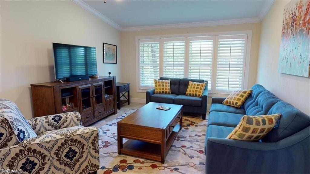 4180 Looking Glass Lane, Unit 4104 Naples, FL 34112 - Photo 11 of 30 a living room with furniture and a window