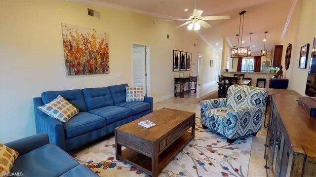 a living room with furniture a rug and a chandelier