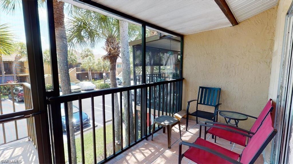 4180 Looking Glass Lane, Unit 4104 Naples, FL 34112 - Photo 2 of 30 a view of a porch with furniture