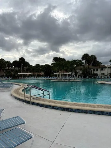a view of a patio with chairs and plants
