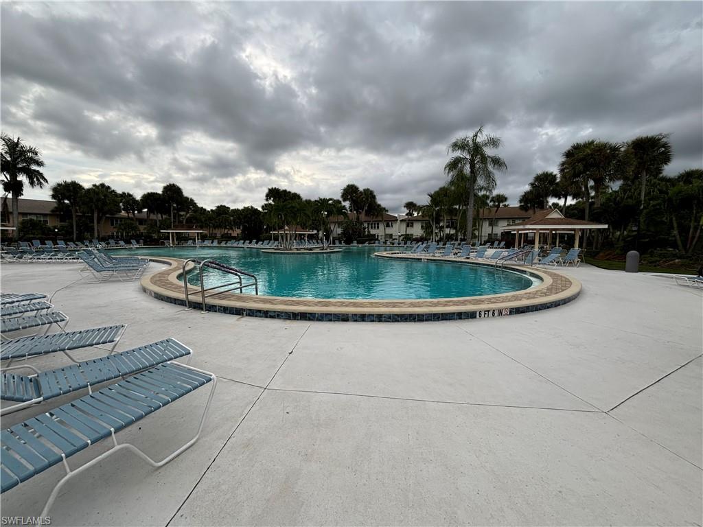 4180 Looking Glass Lane, Unit 4104 Naples, FL 34112 - Photo 22 of 30 a view of a swimming pool with a yard