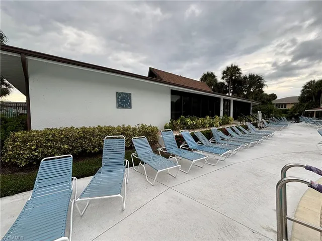 a swimming pool with outdoor seating and yard