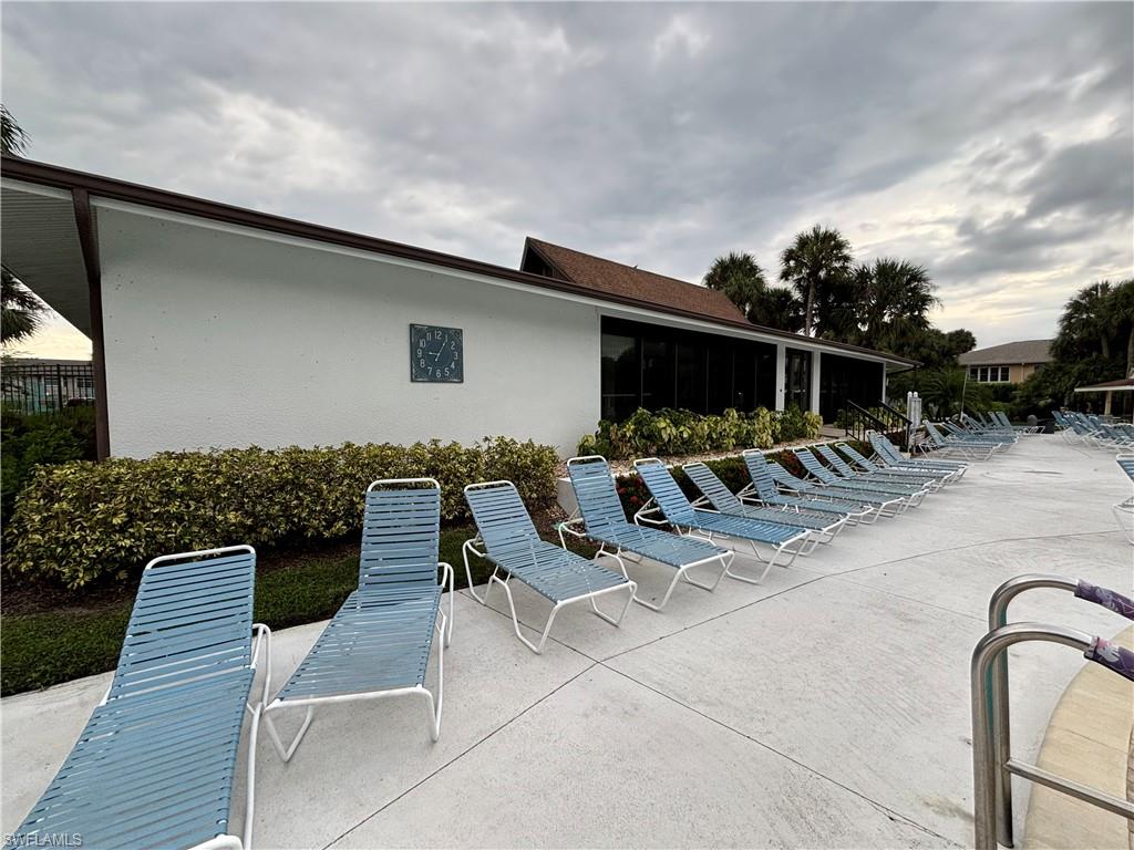 4180 Looking Glass Lane, Unit 4104 Naples, FL 34112 - Photo 23 of 30 a view of a patio with chairs and plants