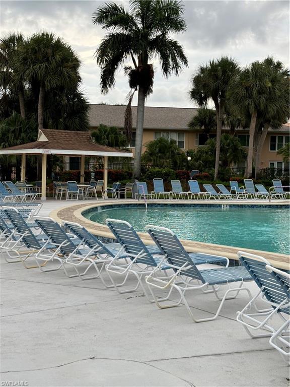 4180 Looking Glass Lane, Unit 4104 Naples, FL 34112 - Photo 25 of 30 a swimming pool with outdoor seating and yard